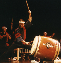 Marco Lienhard plays a taiko on stage in New York