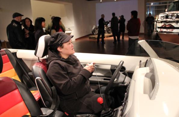 person sitting in scion car playing a video game