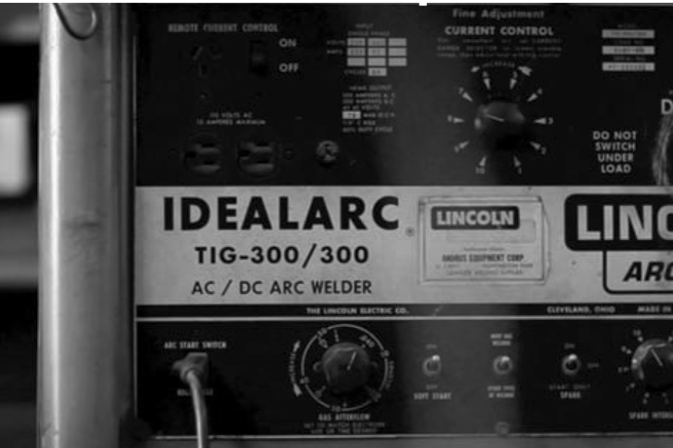black and white photo of welder machine