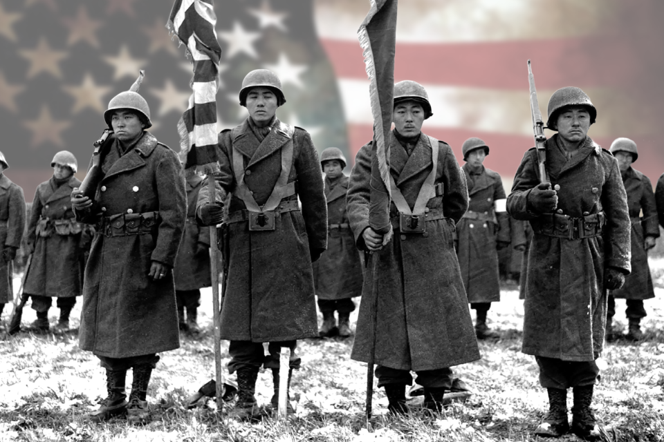 442 soldiers stand in formation with US flag superimposed behind them