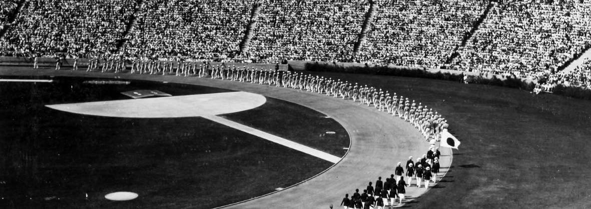 An arial shot by Toyo Miyatake of a stadium with olympic athletes marching from 1932