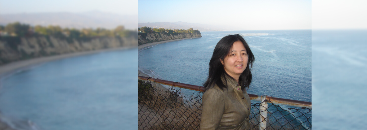 Photograph of Karen Higa taken near the ocean.