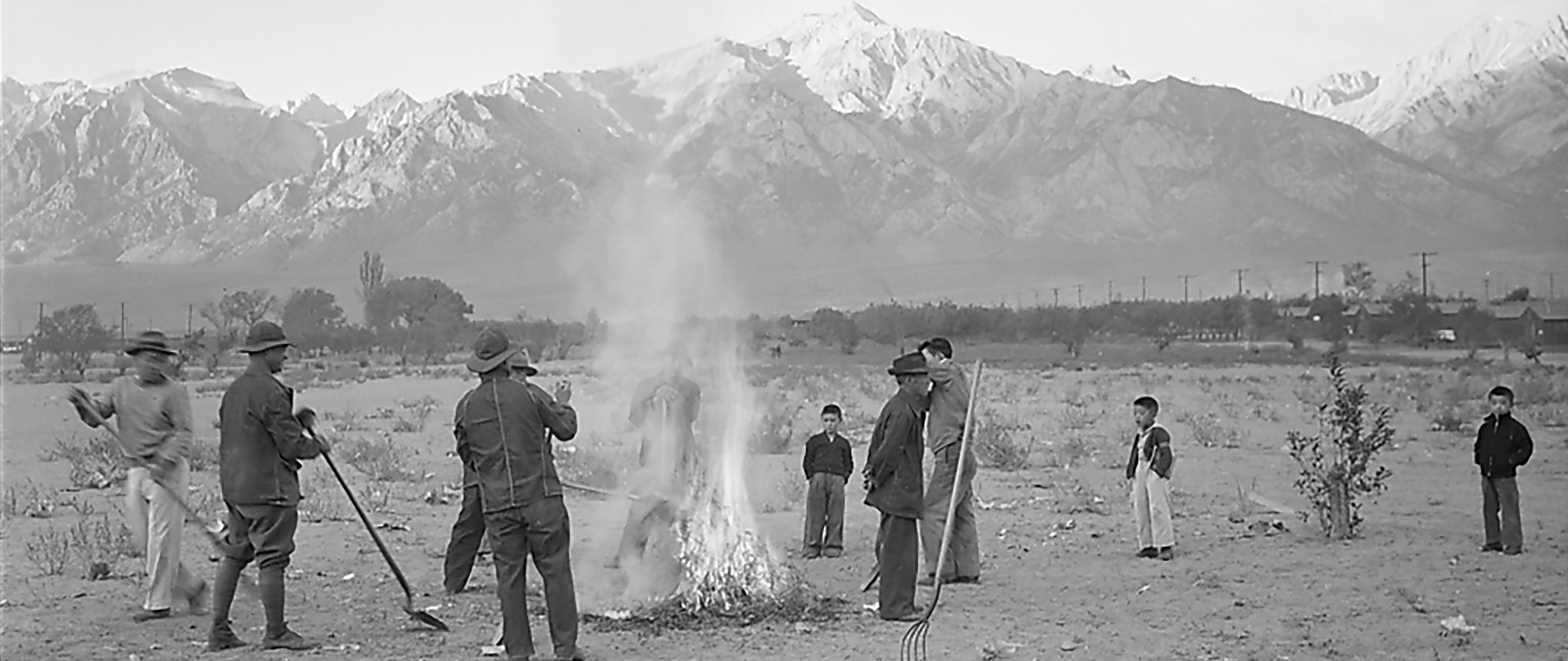 A black and white photo incarcerees Burning Leaves at Manzanar