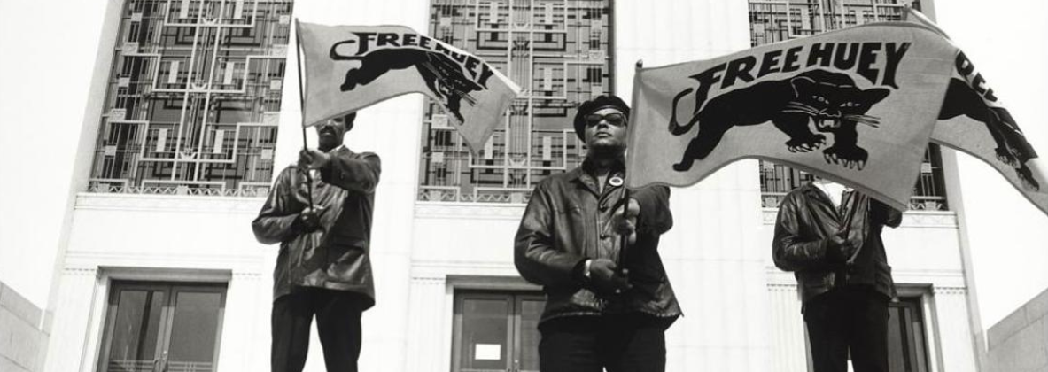 black and white photo of 3 black panthers holding banners