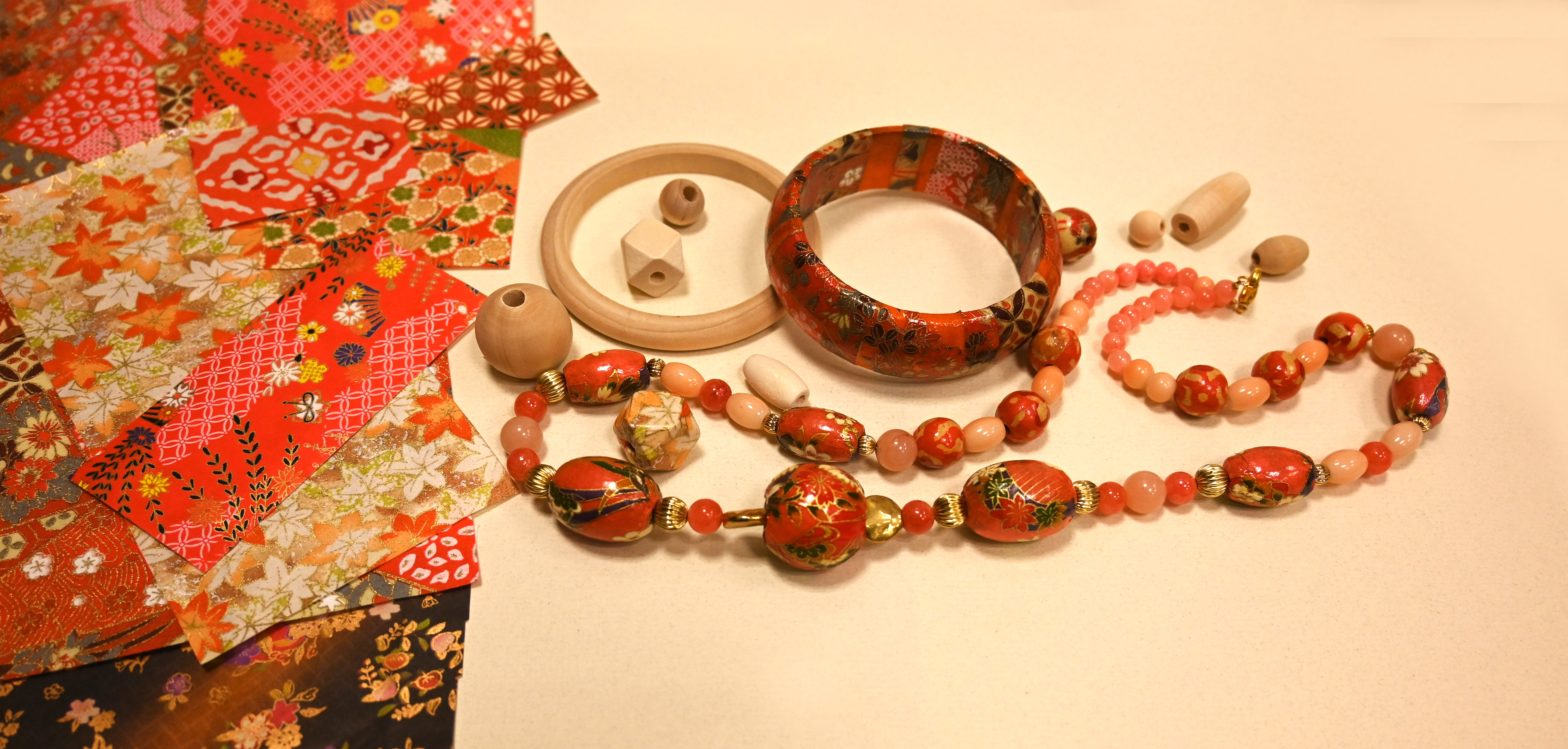 washi paper on table with wooden bracelets and washi paper made necklace