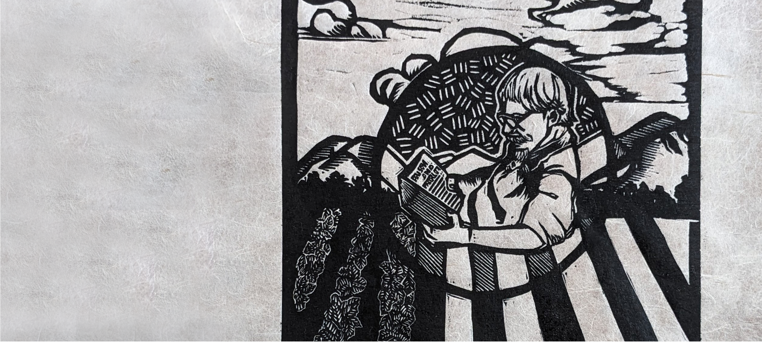 woodblock print of man reading a book with farm fields behind