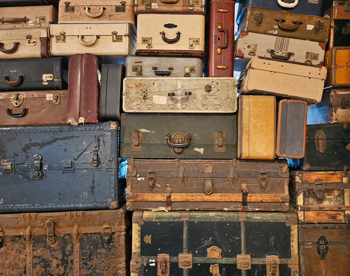 a wall of old suitcases stacked together