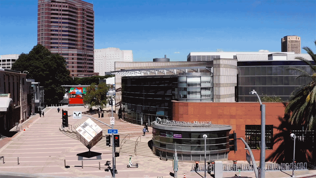 drone footage pulling out from JANM's Pavilion and plaza to wide shot above little tokyo
