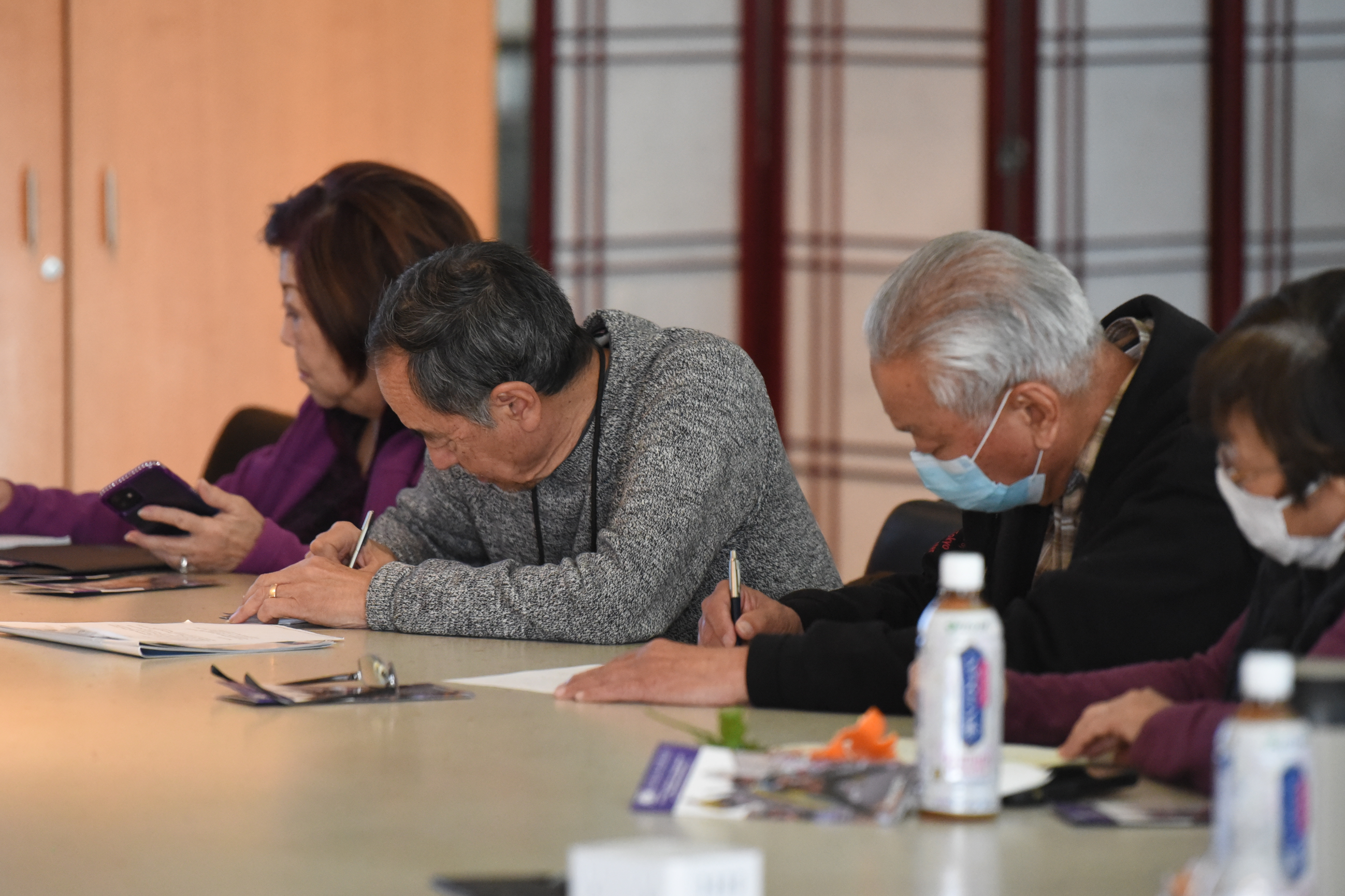 people writing in notebooks