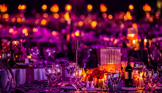 Purple and pink lighting around a table centerpiece