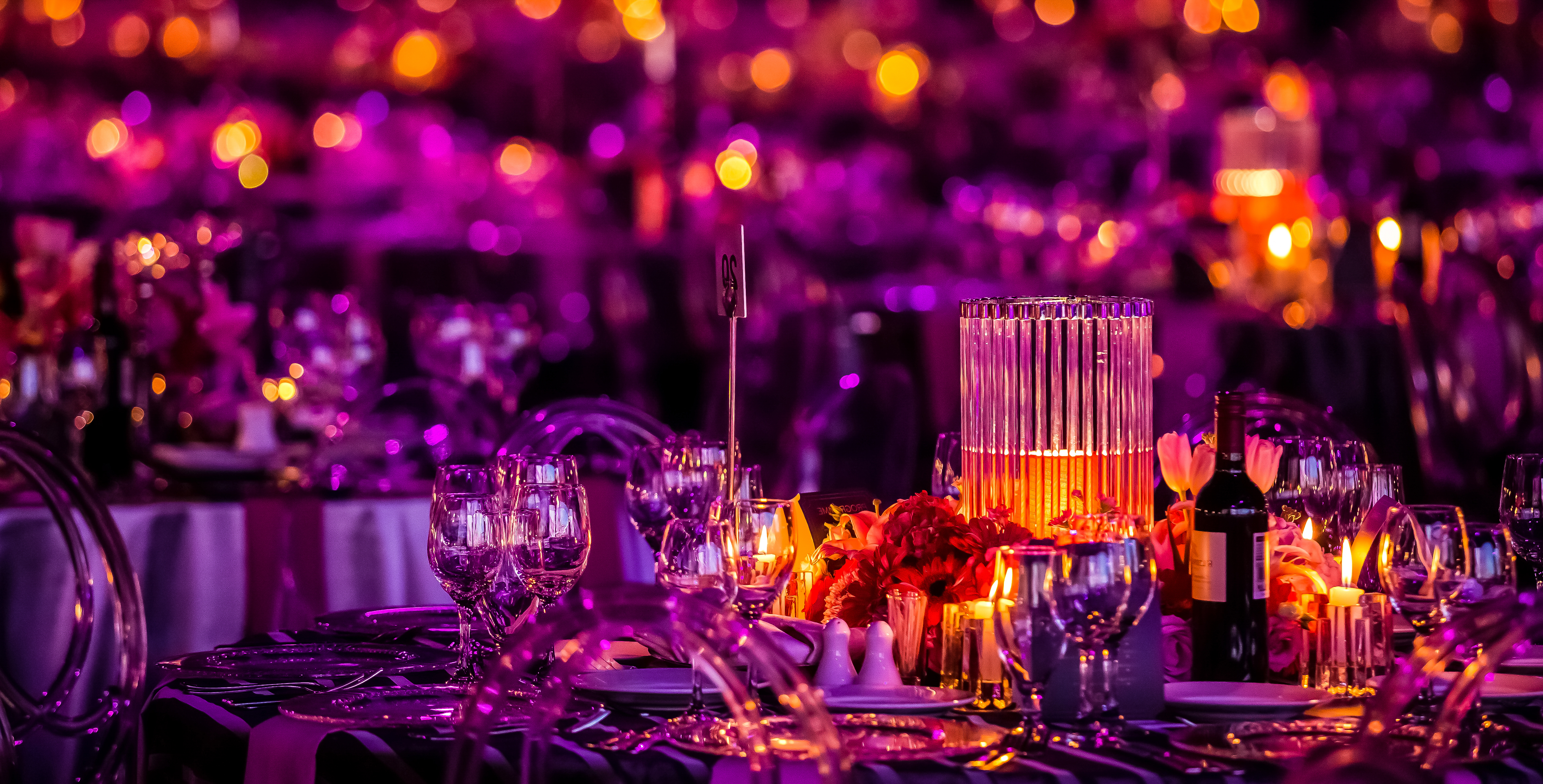 crystal table setting in purple lighting and candles