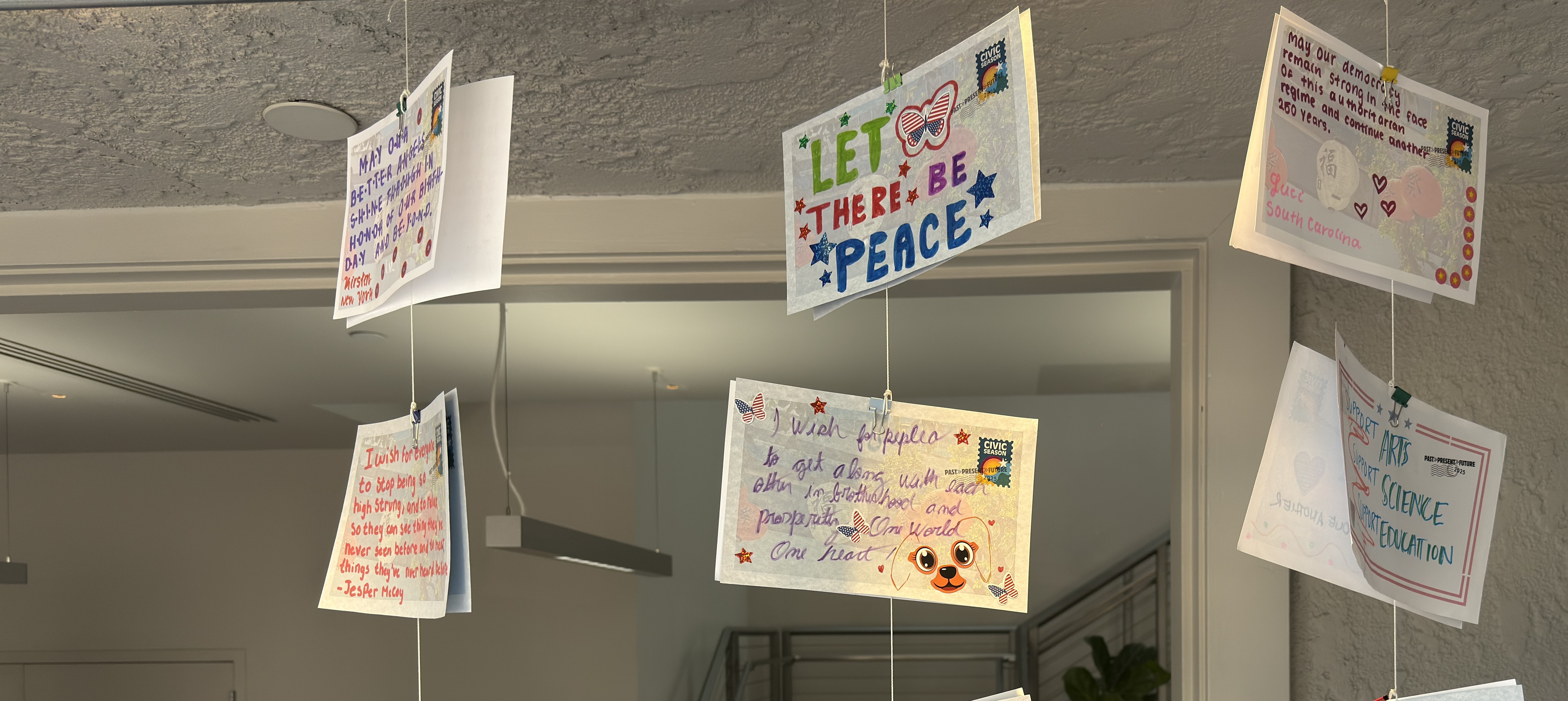 wish wall postcards hanging display in window