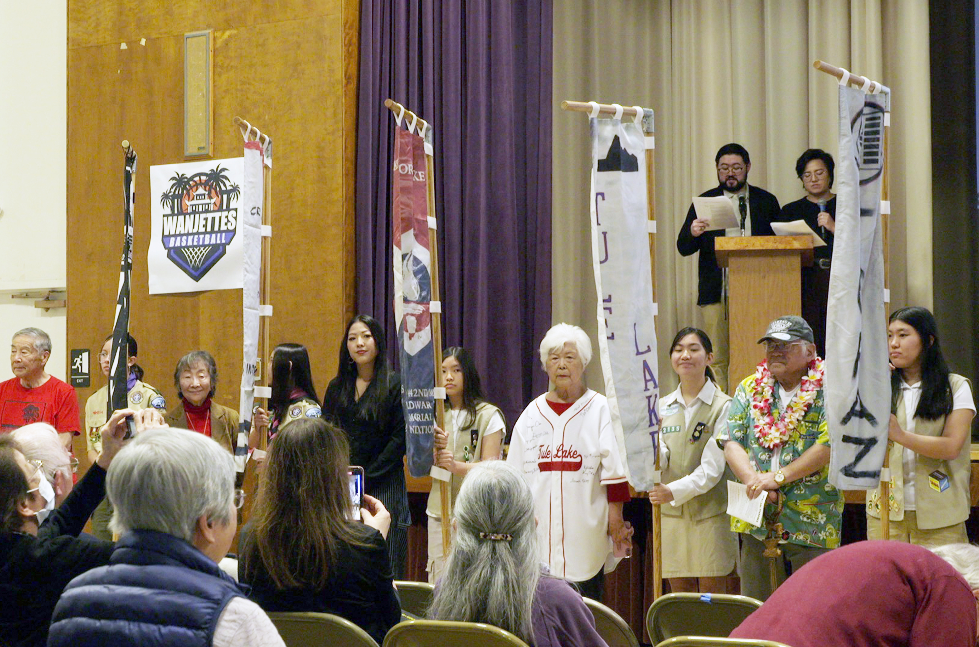 Day Of Remembrance program, people holding the flags of the camps