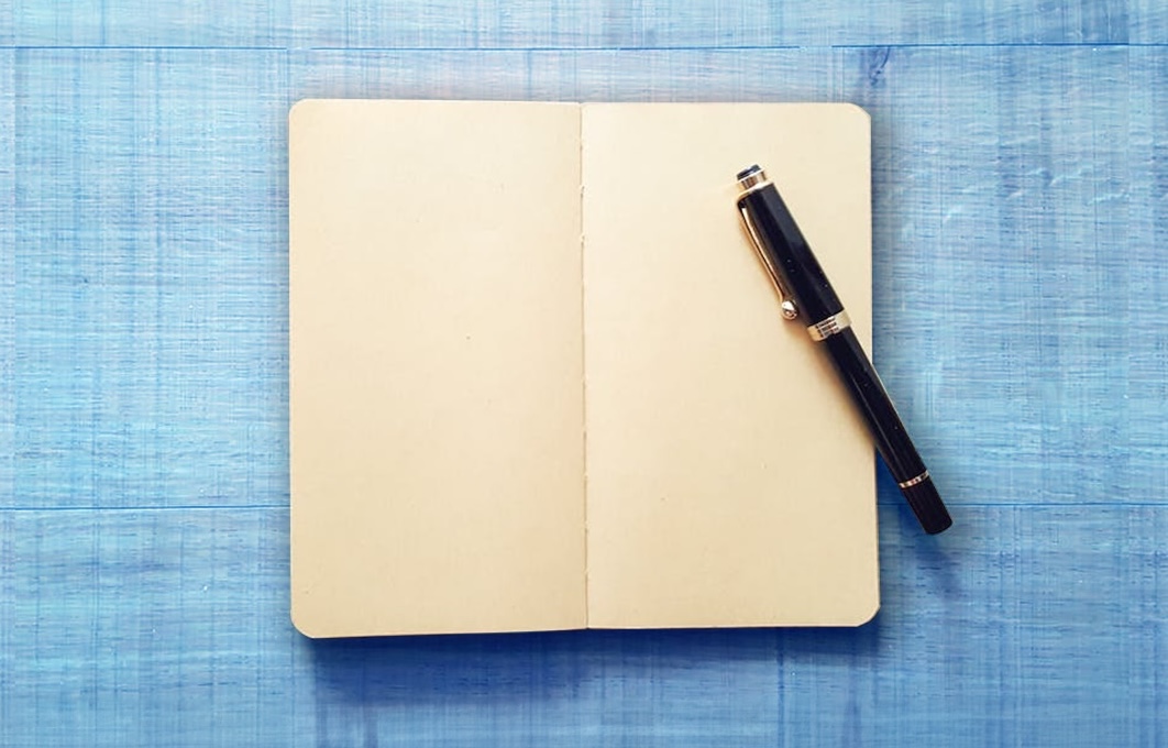 Book with blank pages and pen