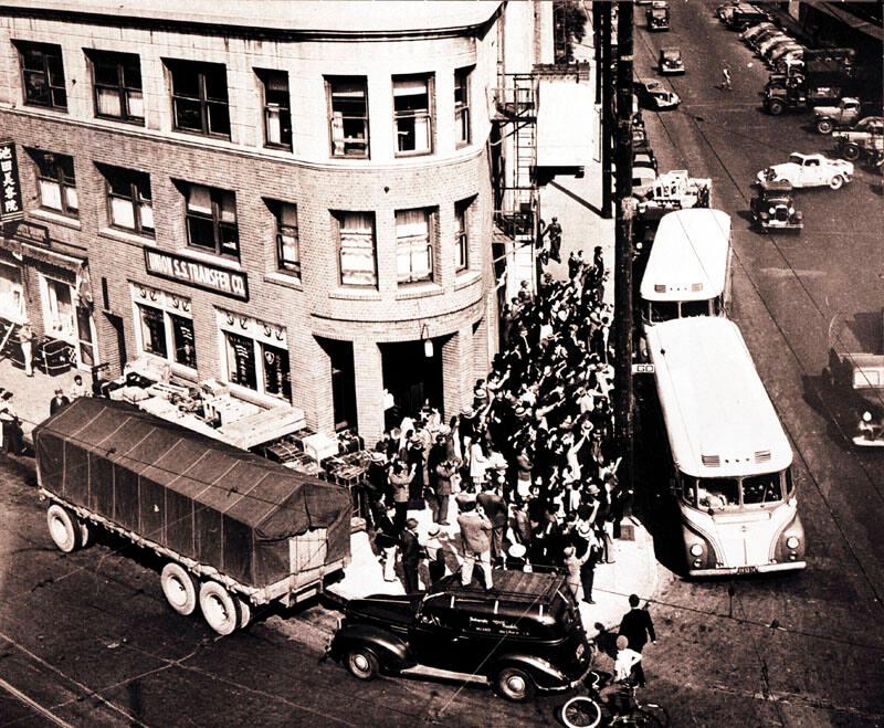 Aerial perspective of crowd boarding buses in front of Nishi Hongwanji Buddhist Temple, 