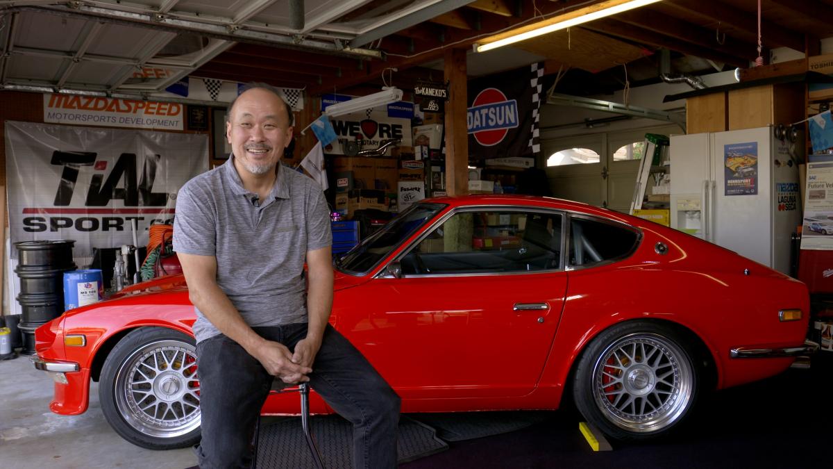 Tod Kaneko sitting in front of his Datsun 240Z