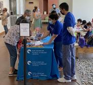 LA public library booth signing up visitors to a free library card