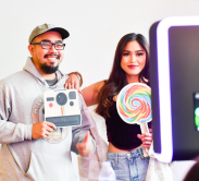 two visitors at the family festival at janm posing with props at photo booth