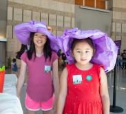 two girls wearing their paper craft hats