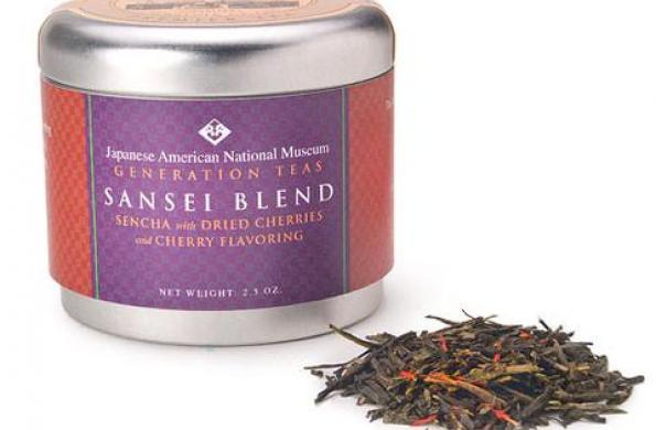 tin canister with purple and red label that says "Japanese American National Museum Generation Teas Sansei Blend" and a small scoop of tea leaves sitting next to it