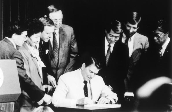 Ronald Regan signing the 1988 Civil Liberties Act