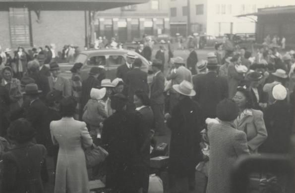 Japanese Americans waiting at Santa Fe station post concentration camp