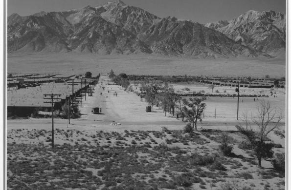 Mountains in the background and concentration camps in the midground of black and white Ansel Adams image