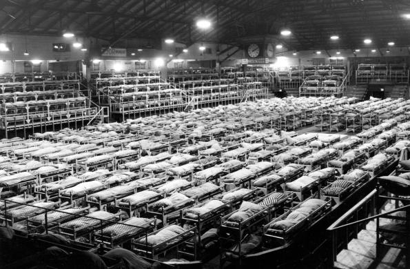 Large indoor space with as many cots crammed close together