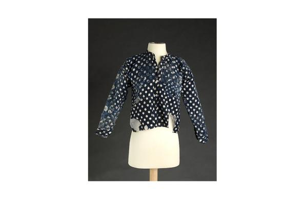 Navy blue Kasuri Jacket with white spots adapted from a kimono sits on a headless mannequin for display