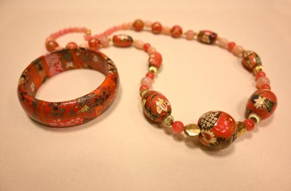 A necklace and bracelet made using Japanese paper and wooden beads.