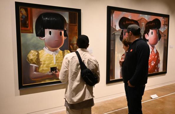 visitors looking at paintings by giorgiko