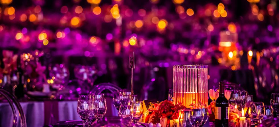 Purple and pink lighting around a table centerpiece