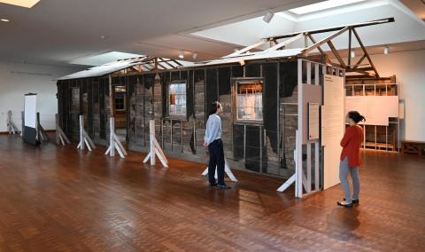 2 people looking at the heart mountain barrack in the museum