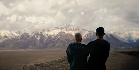 Father and son looking at the mountains behind Manzanar concentration camp