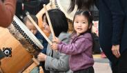 little girl playing taiko drum 