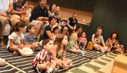 kids and parents sitting and listening to a book reading