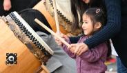 little girl playing taiko drum