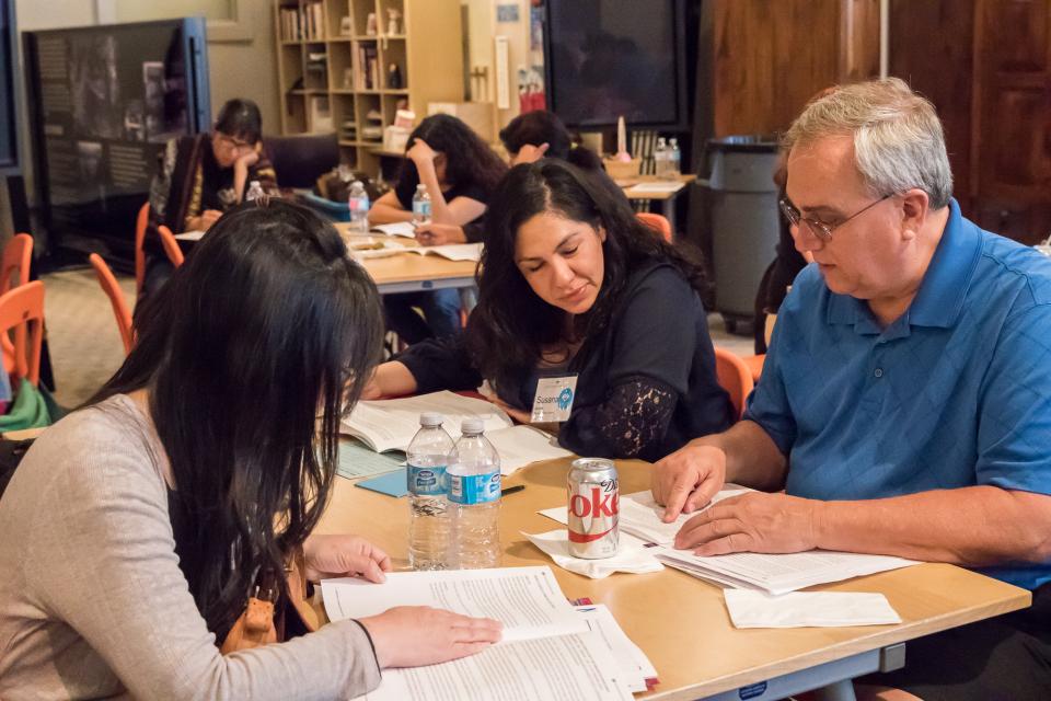 People sitting around table learning at JANM education workshop