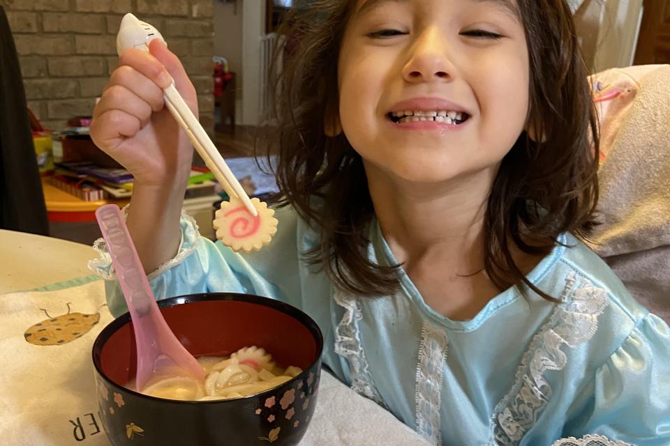 Girl eating ozoni on New Year's Day 2021