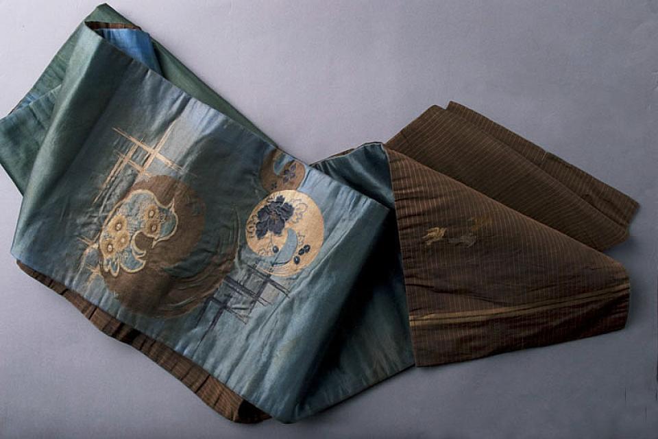 Double-sided obi with brown bird design and brown and gold swirls on blue-green design