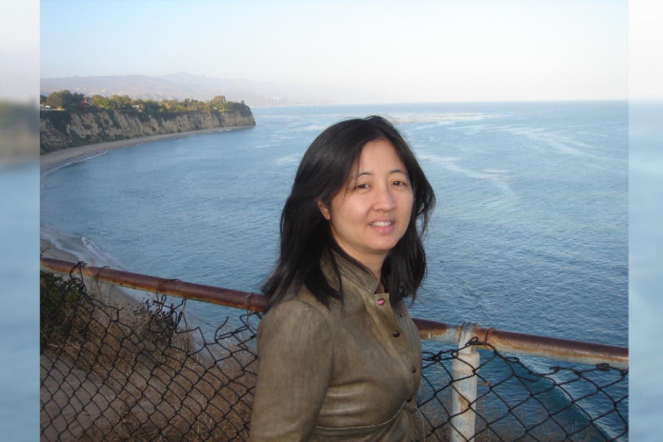 Photograph of Karen Higa taken near the ocean.