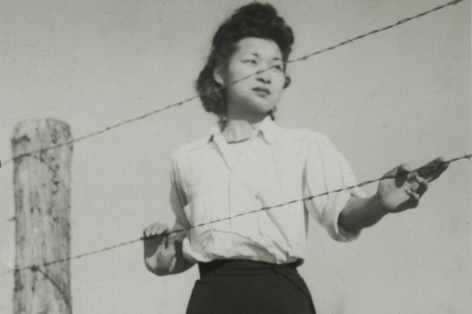 woman behind barbed wire