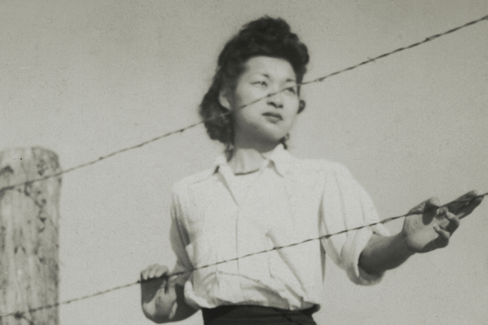 woman behind barbed wire