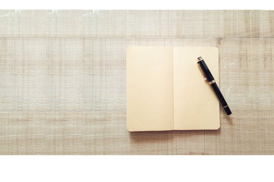 Journal with pen on textured background