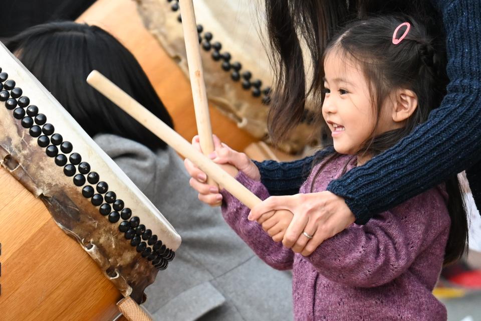 Little girl playing the taiko drums