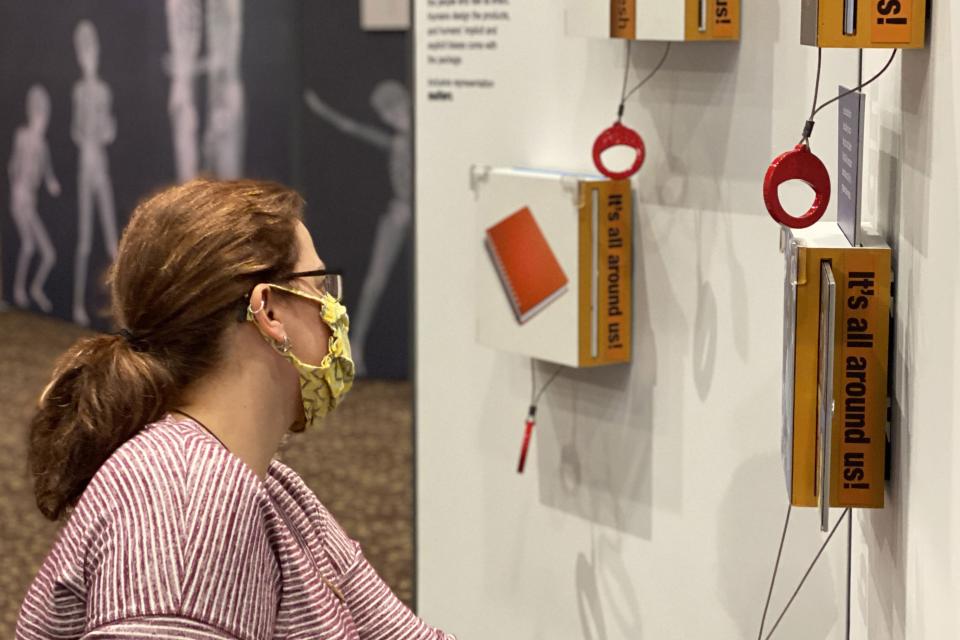 a woman interacting with the smithsonian bias inside us exhibition 