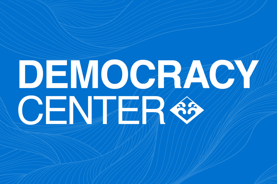 Democracy Center logo over blue wave pattern