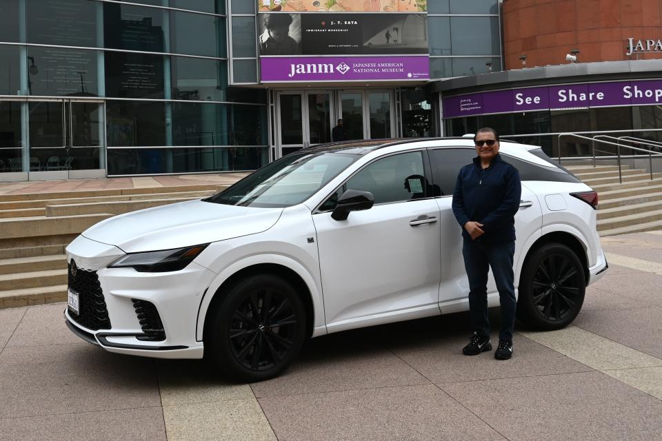 man standing in front of car