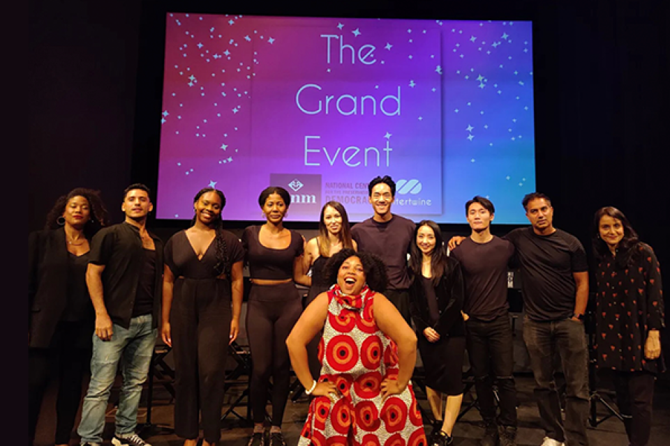 participants in the grand play event on stage