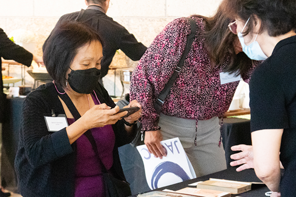 people viewing objects on table